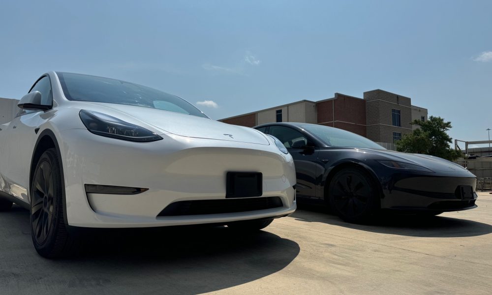 Two repaired Tesla vehicles parked outside Core Collision Kyle-Buda