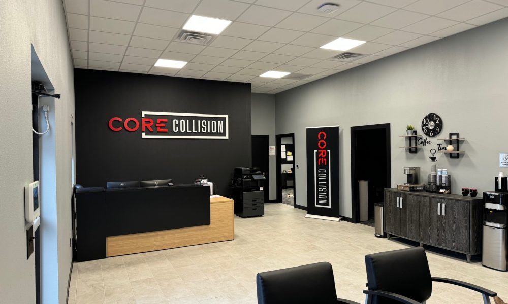 Welcoming lobby at Core Collision Georgetown featuring the reception counter, company logo wall, seating area, and customer amenities