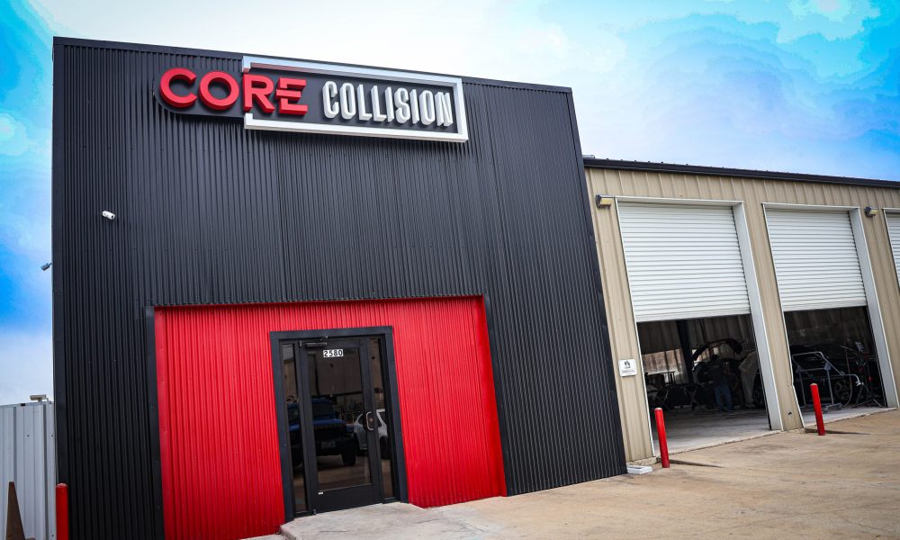 Exterior of the Core Collision auto body repair shop in Kyle, TX with the business sign above the main entrance and service bays.